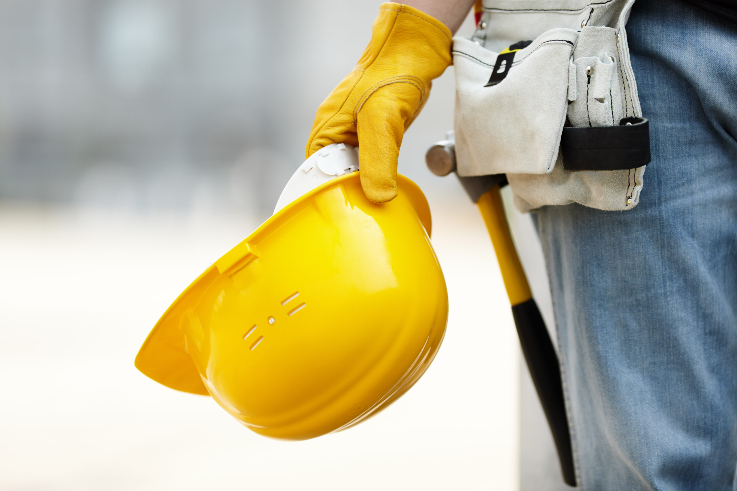 a man holding a hard hat on a safe construction site with trs equipment rental
