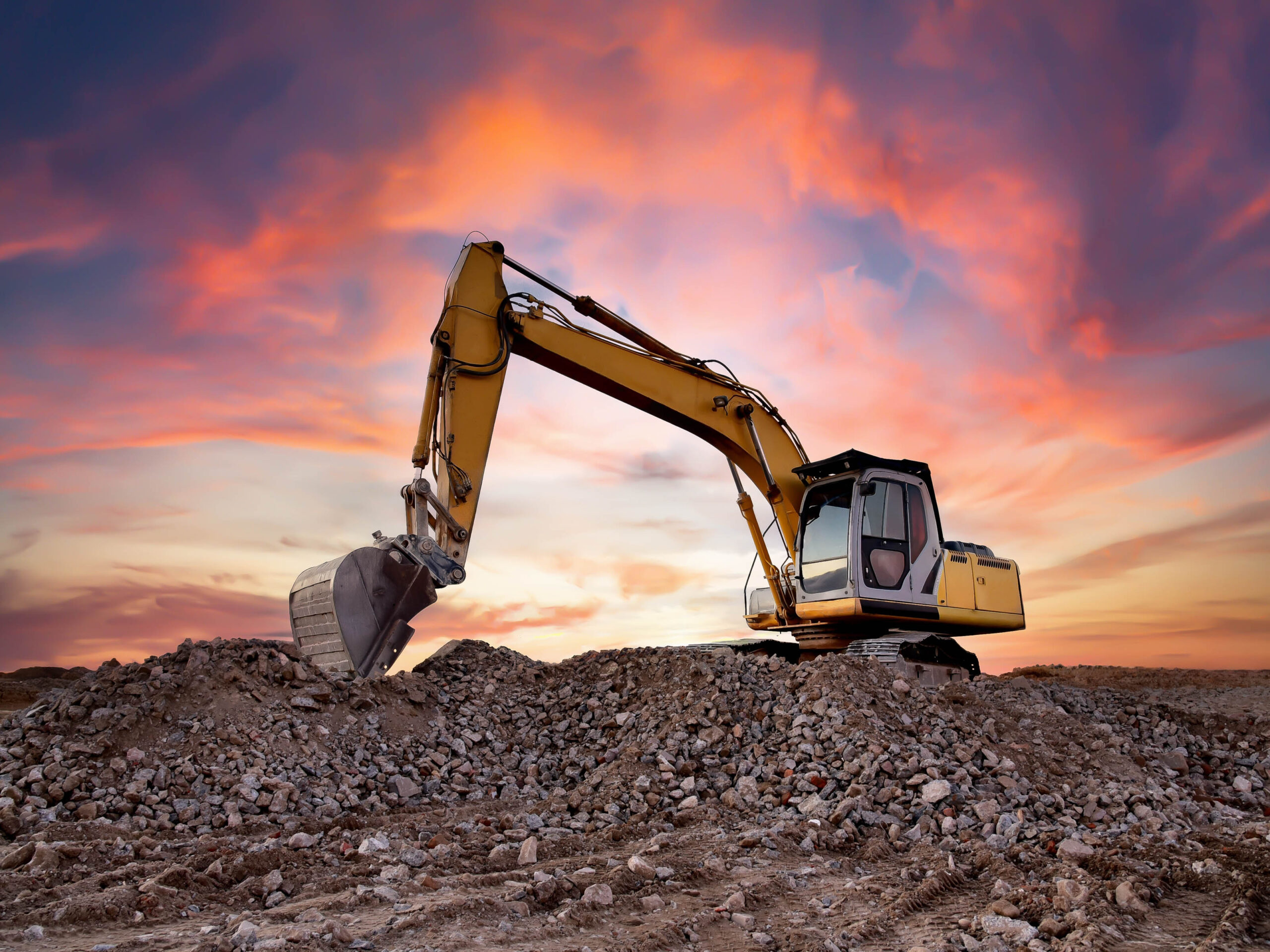 excavator carrying soil on a construction site for the first time with rented equipment
